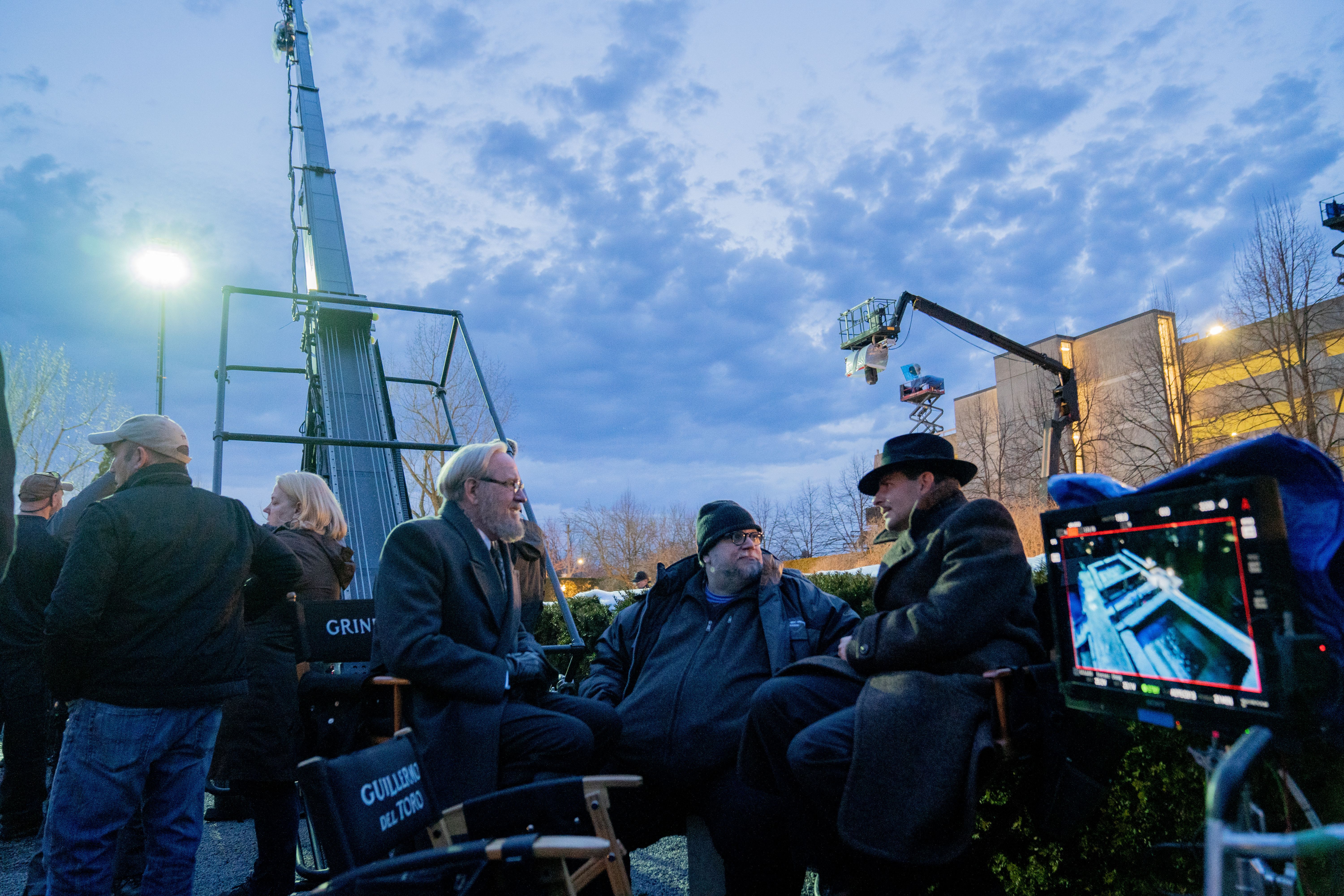 J. Miles Dale, Richard Jenkins, Guillermo del Toro and Bradley Cooper in the film NIGHTMARE ALLEY