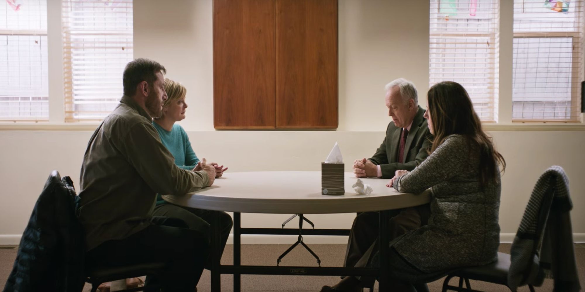 Two couple sit and discuss a tragedy in Mass