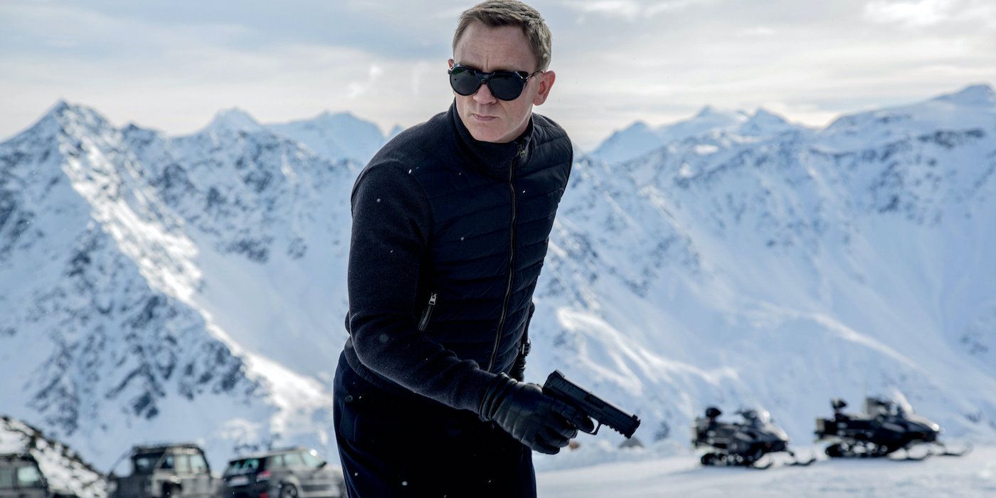 James Bond holding a gun in a snowy mountain in the film Spectre.