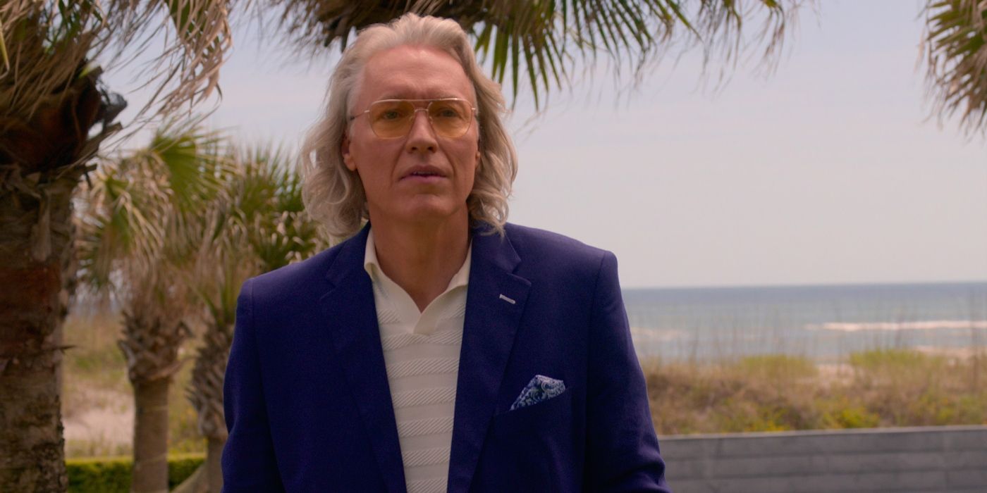 Terry Silver wearing glasses and a suit in Cobra Kai.