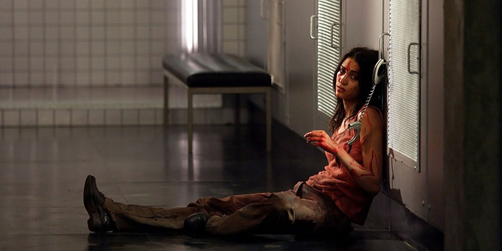 Morjana Alaoui sits handcuffed to a door