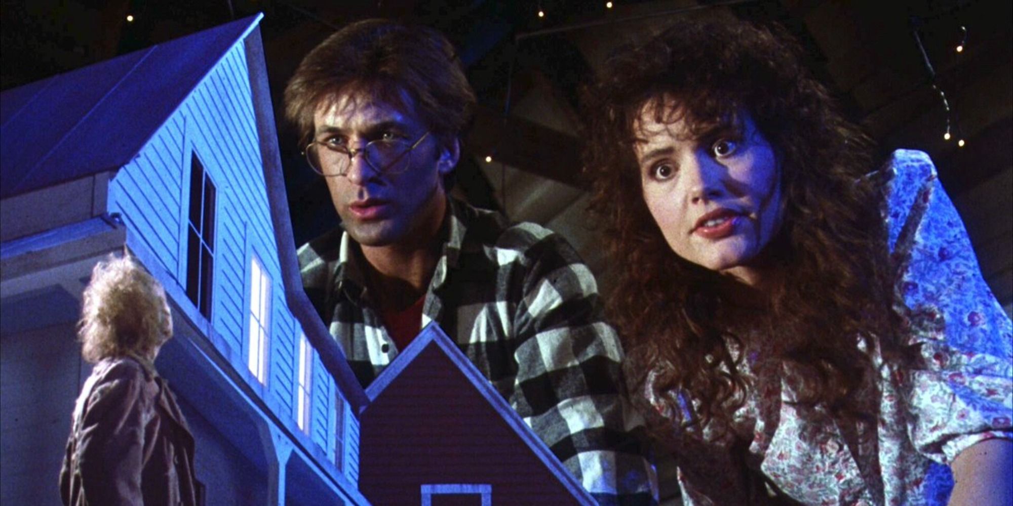 Adam and Barbara Maitland looking at a model of their home in Beetlejuice