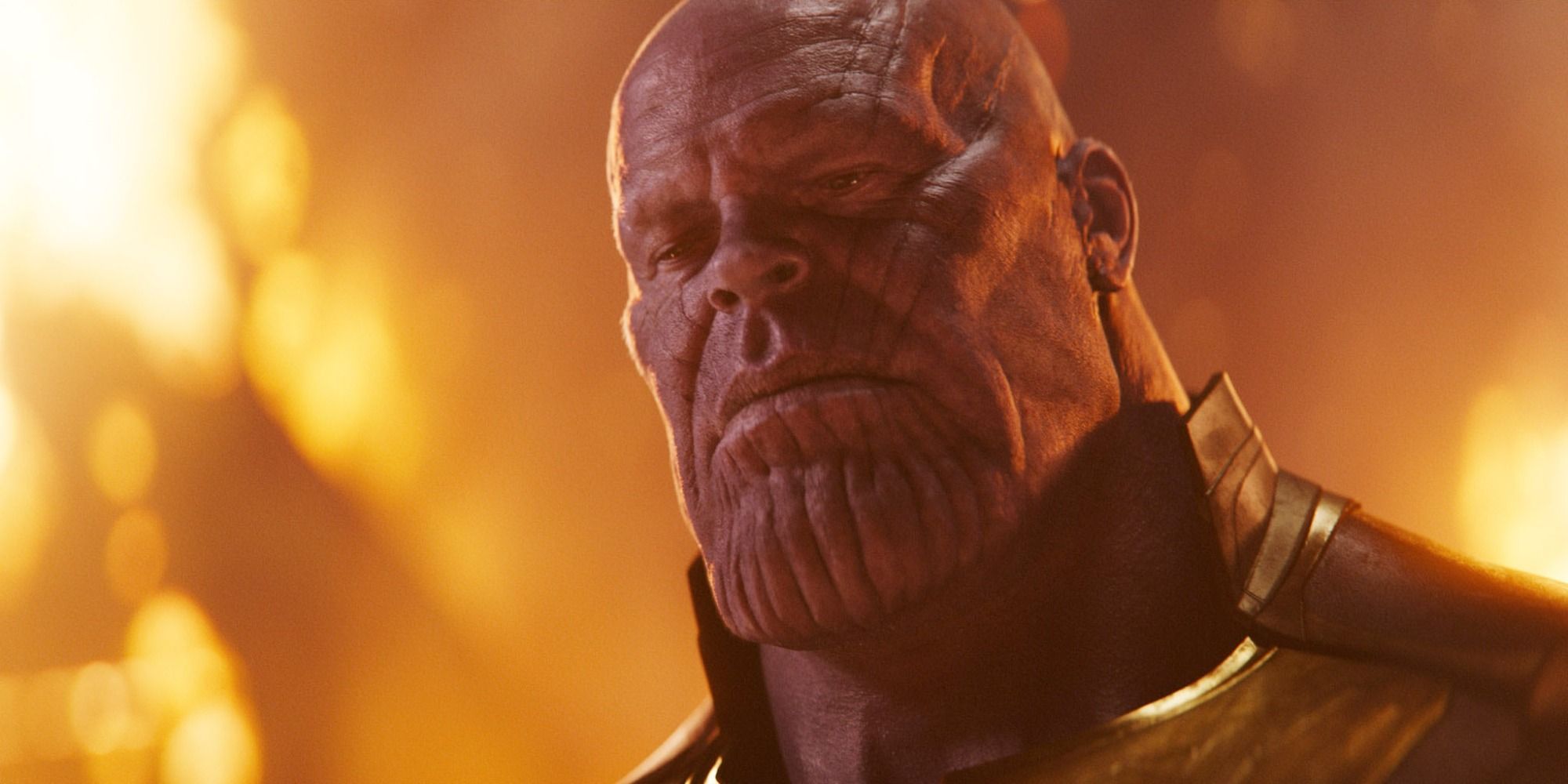 The Mad Titan Thanos close-up with a calm expression and fiery background