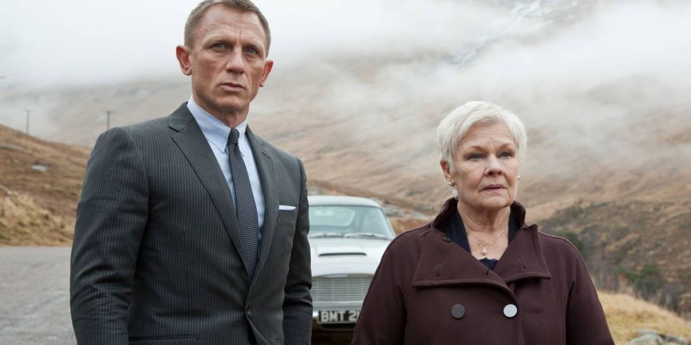 Daniel Craig and Judi Dench as Bond and M standing in a misty road in Skyfall.