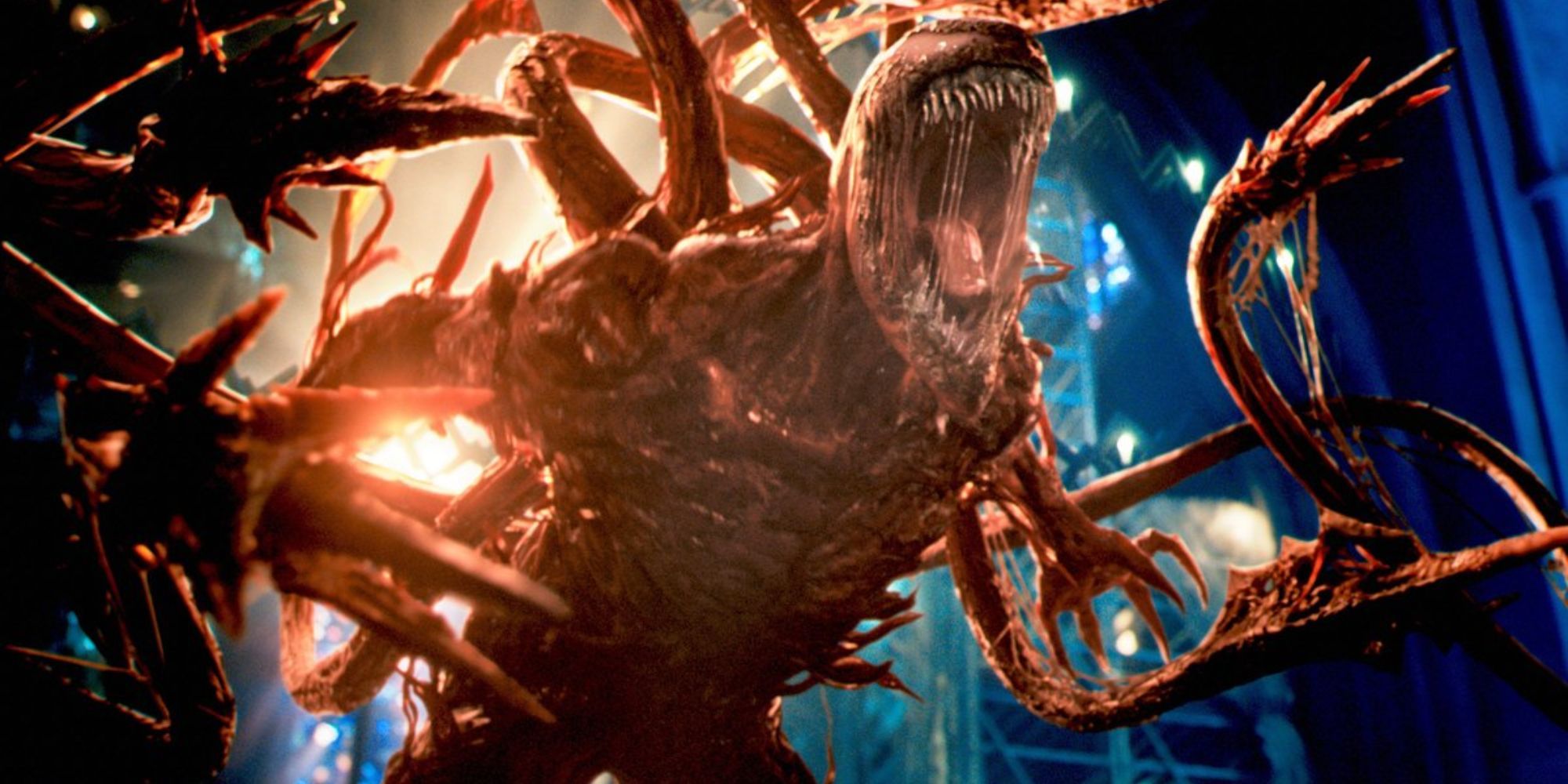 Carnage roaring in rage with tentacles coming out of his back in Venom: Let There Be Carnage