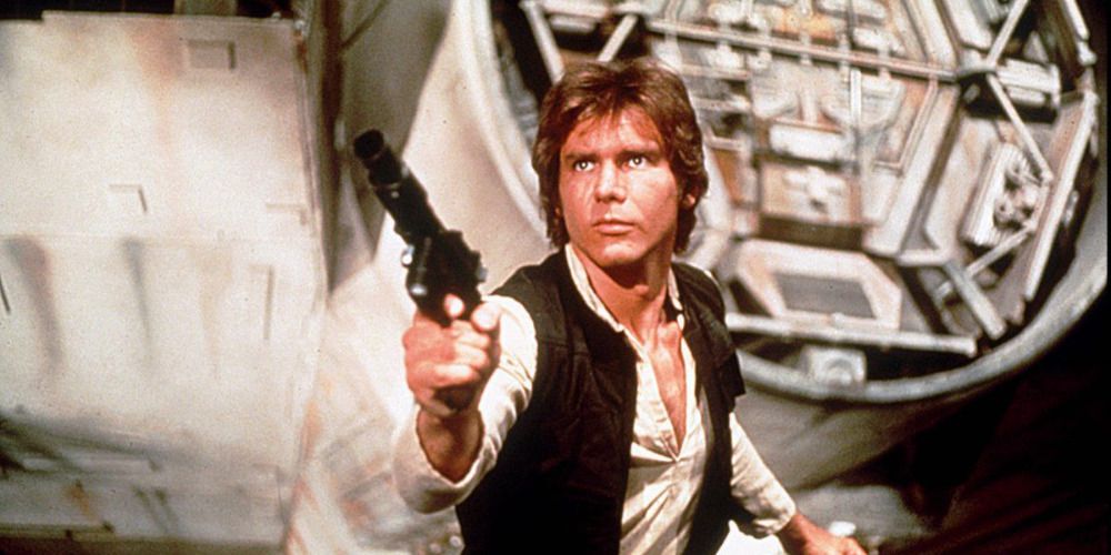Harrison Ford as Han Solo aiming a blaster gun in Star Wars