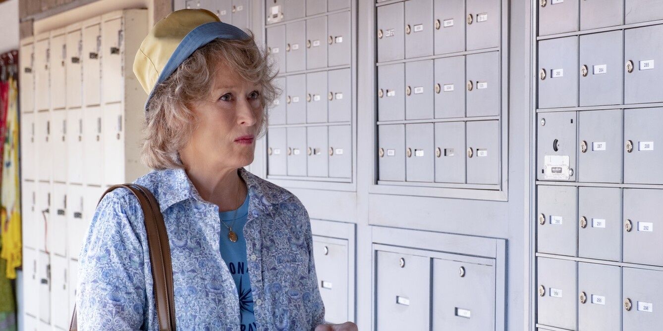 Meryl Streep as Ellen Martin standing near security lockboxes in the movie, The Laundromat