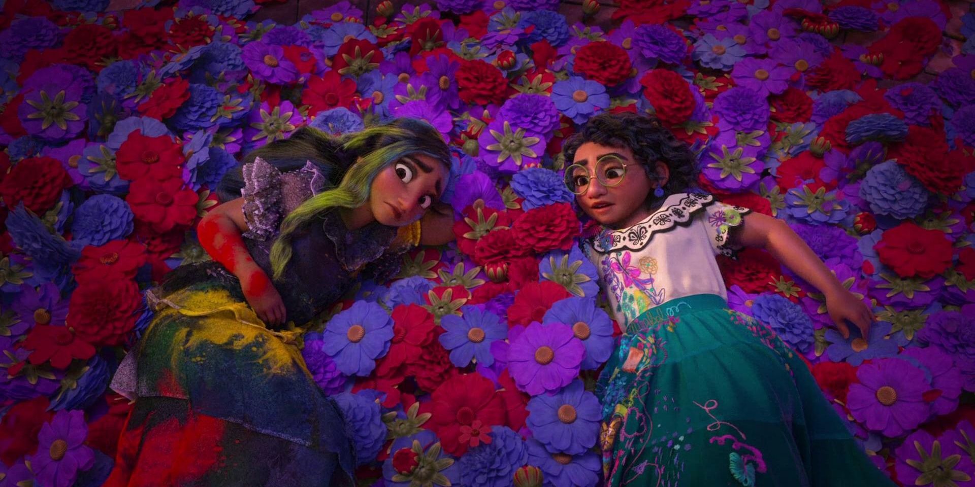 Stephanie Beatriz as Mirabel and Diane Guerrero as Isabel laying in a pile of flowers in Encanto