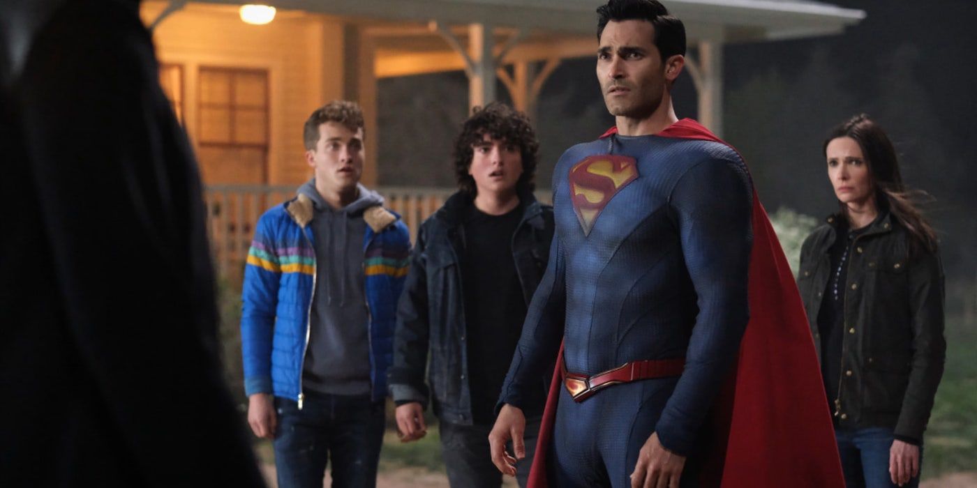 Superman, played by Tyler Hoechlin, and Lois, played by Elizabeth Tulloch, and their kids, Jon, played by Jordan Elsass, and Jordan, played by Alex Garfin, standing on their lawn looking shocked and scared in The CW's Superman and Lois