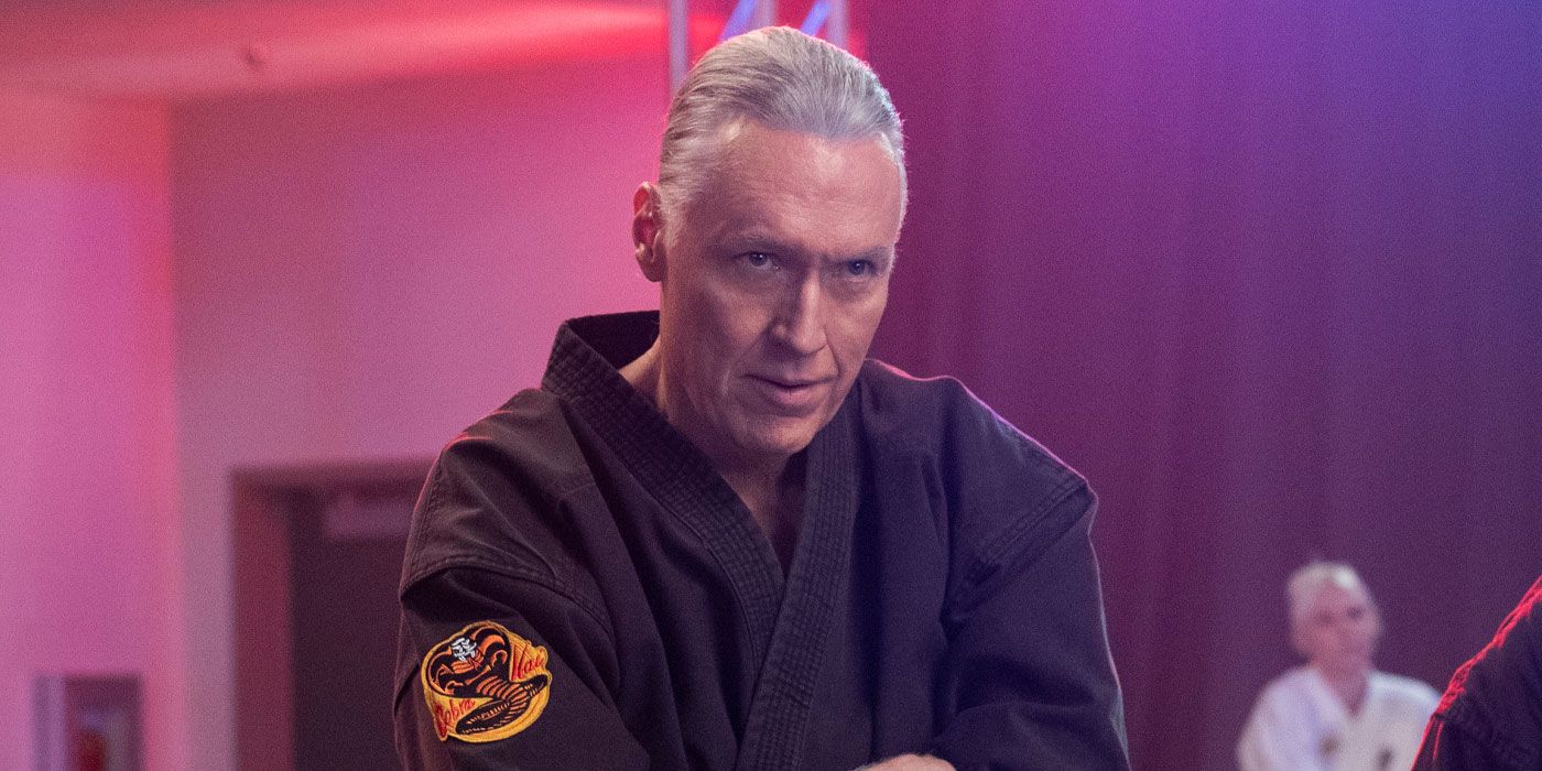 Terry Silver at his dojo with his arms crossed looking intently in Cobra Kai