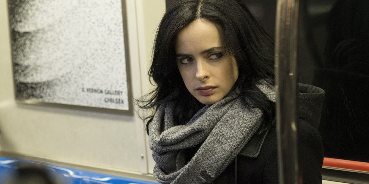 Krysten Ritter as Jessica Jones sitting in a subway and looking to the side in 'Jessica Jones'.