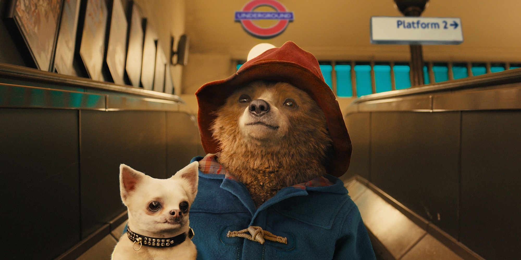 Paddington Bear going down a set of electrical stairs at the London tube in the film Paddington