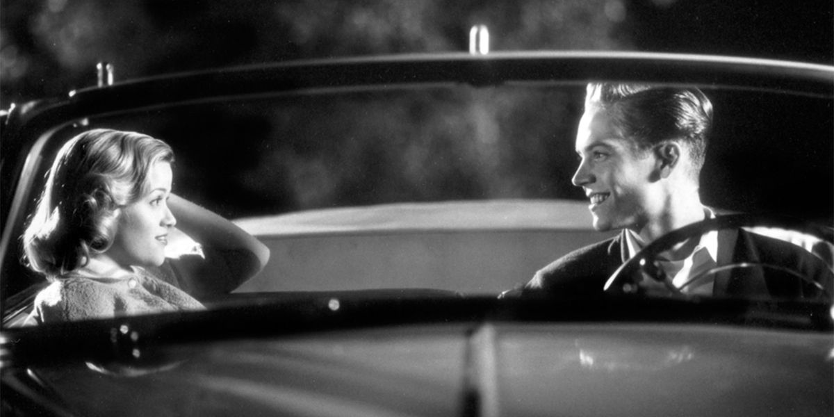 Mary Sue and Skip smiling at each other in a car in Pleasantville.
