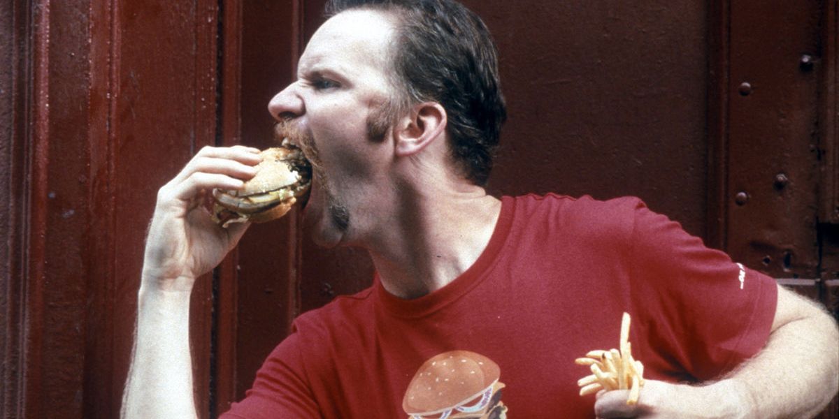 Morgan Spurlock eating a burger and fries in Super Size Me