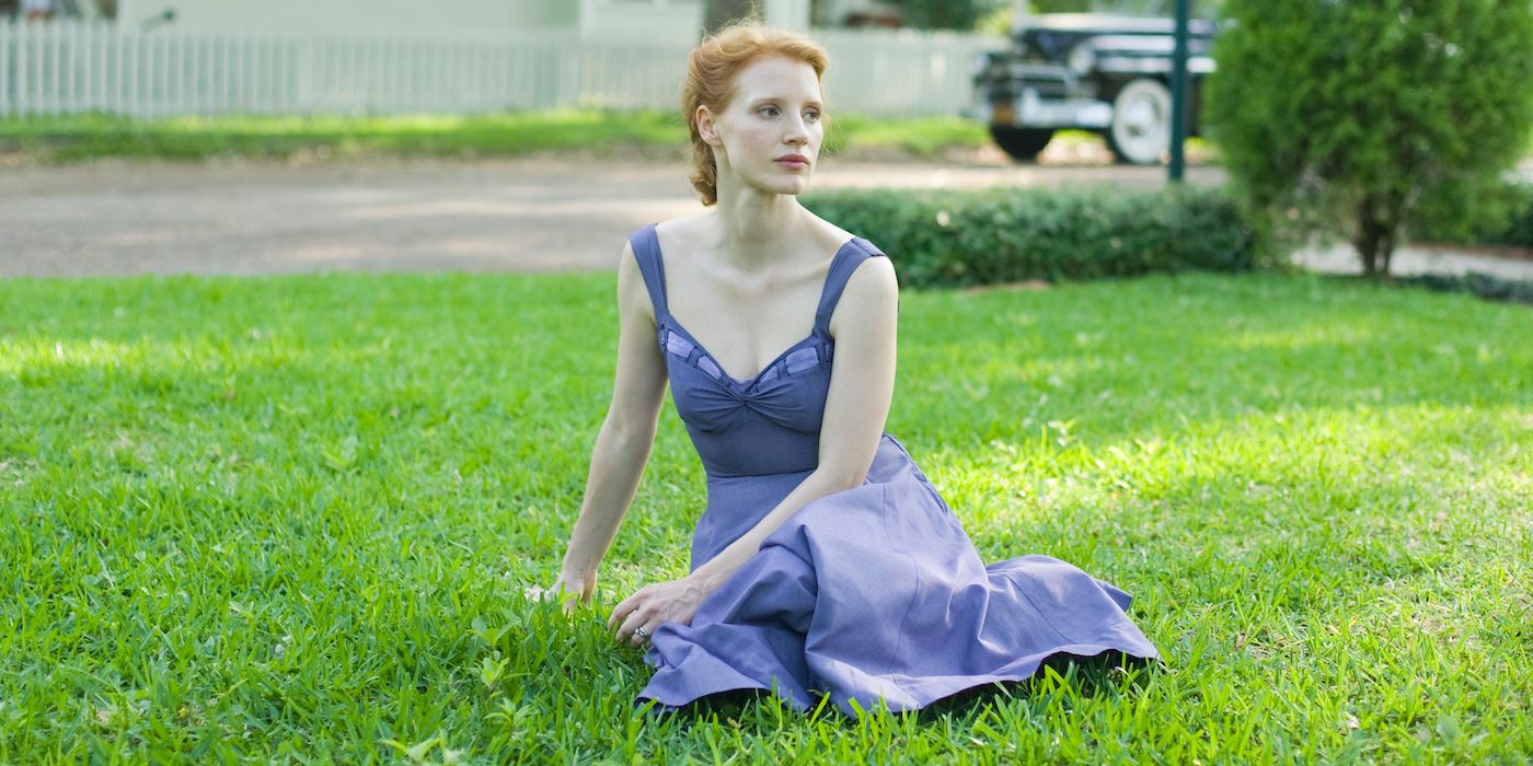 A woman laying on a garden looking to the distance in The Tree of Life