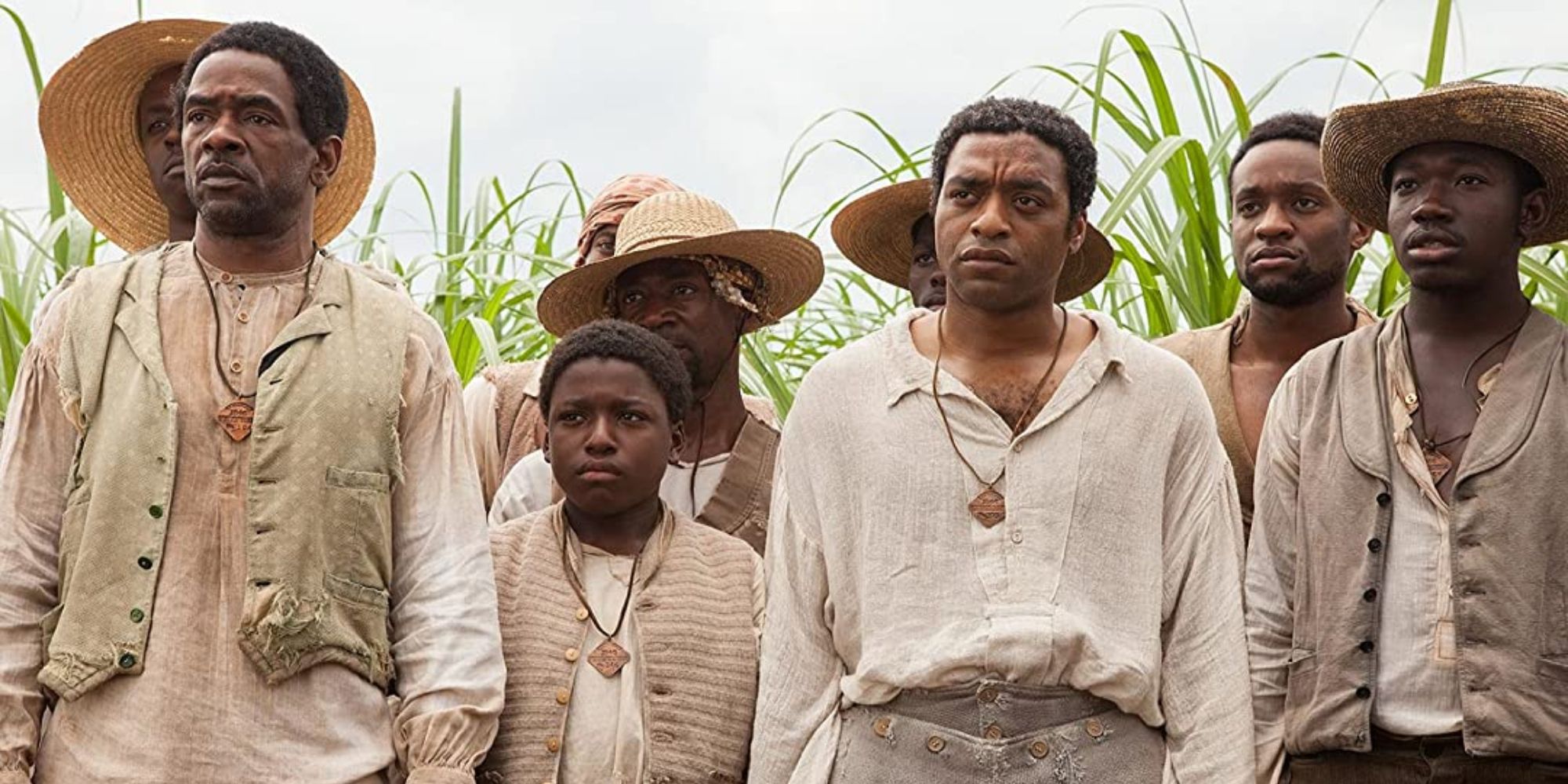 Solomon Northup and a group of Black slaves looking ahead in 12 Years a Slave