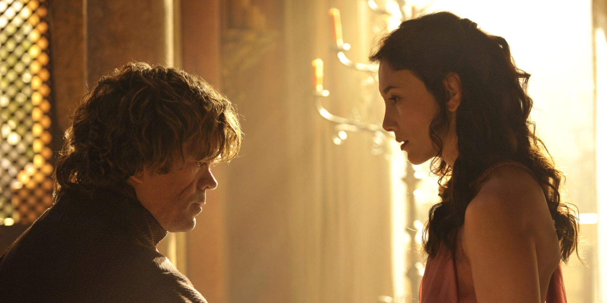 Tyrion and Shae sharing a conversation in a bedroom with the sun shining behind them in Game of Thrones