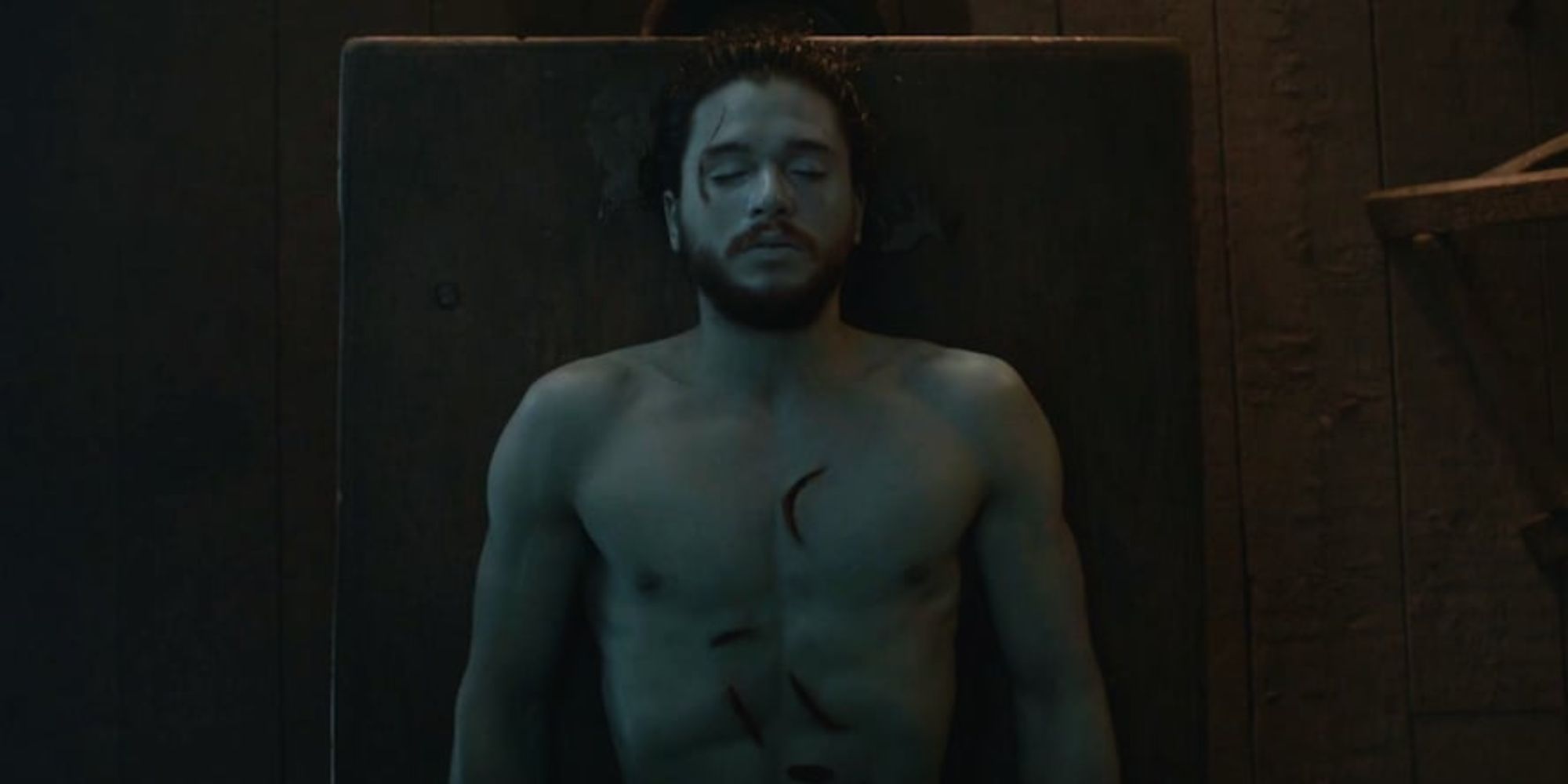 Jon Snow, laying dead on a slab before coming back to life in Game of Thrones.