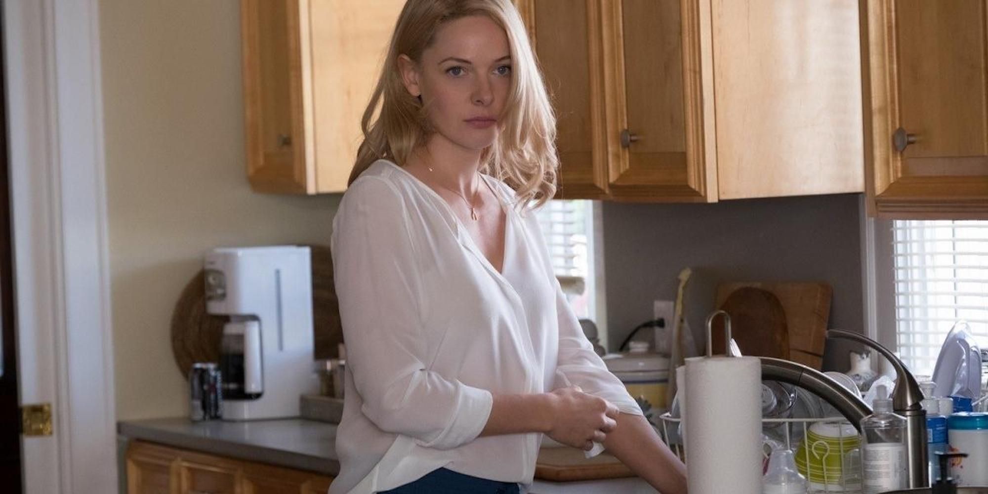 Anne Watson (Rebecca Ferguson) stands in a kitchen in 'The Girl on the Train'.