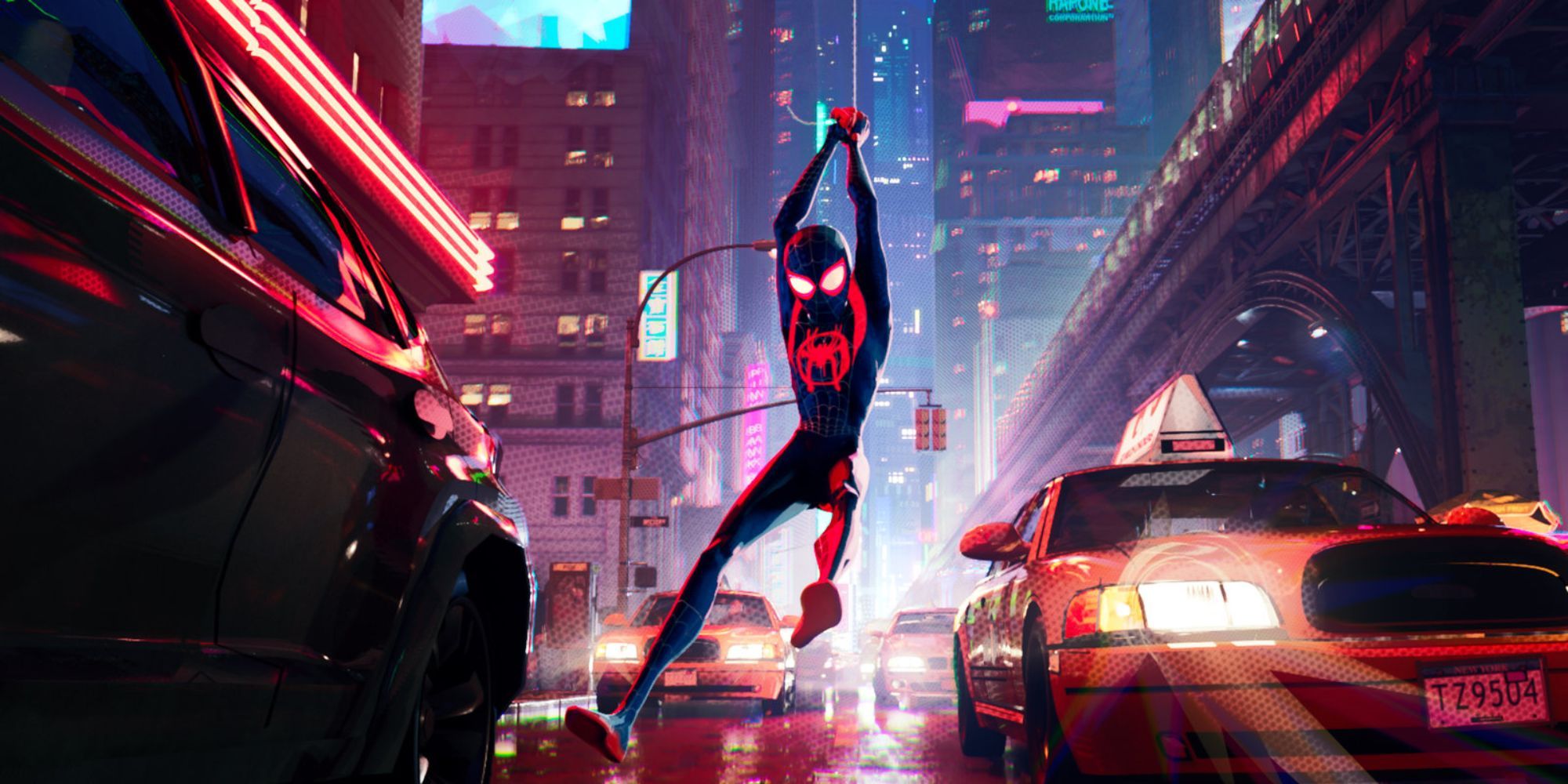 A still animation image from Spider-Man: Into The Spider-Verse, featuring Miles Morales swinging through the city. 