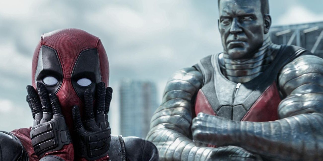 Deadpool with hands on his face making a surprised expression through mask, Colossus in background with arms crossed
