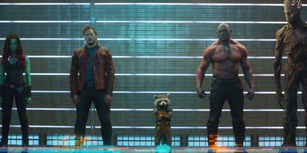 Gamora, Peter Quill, Rocket, Drax and Groot stand side by side in a police line up