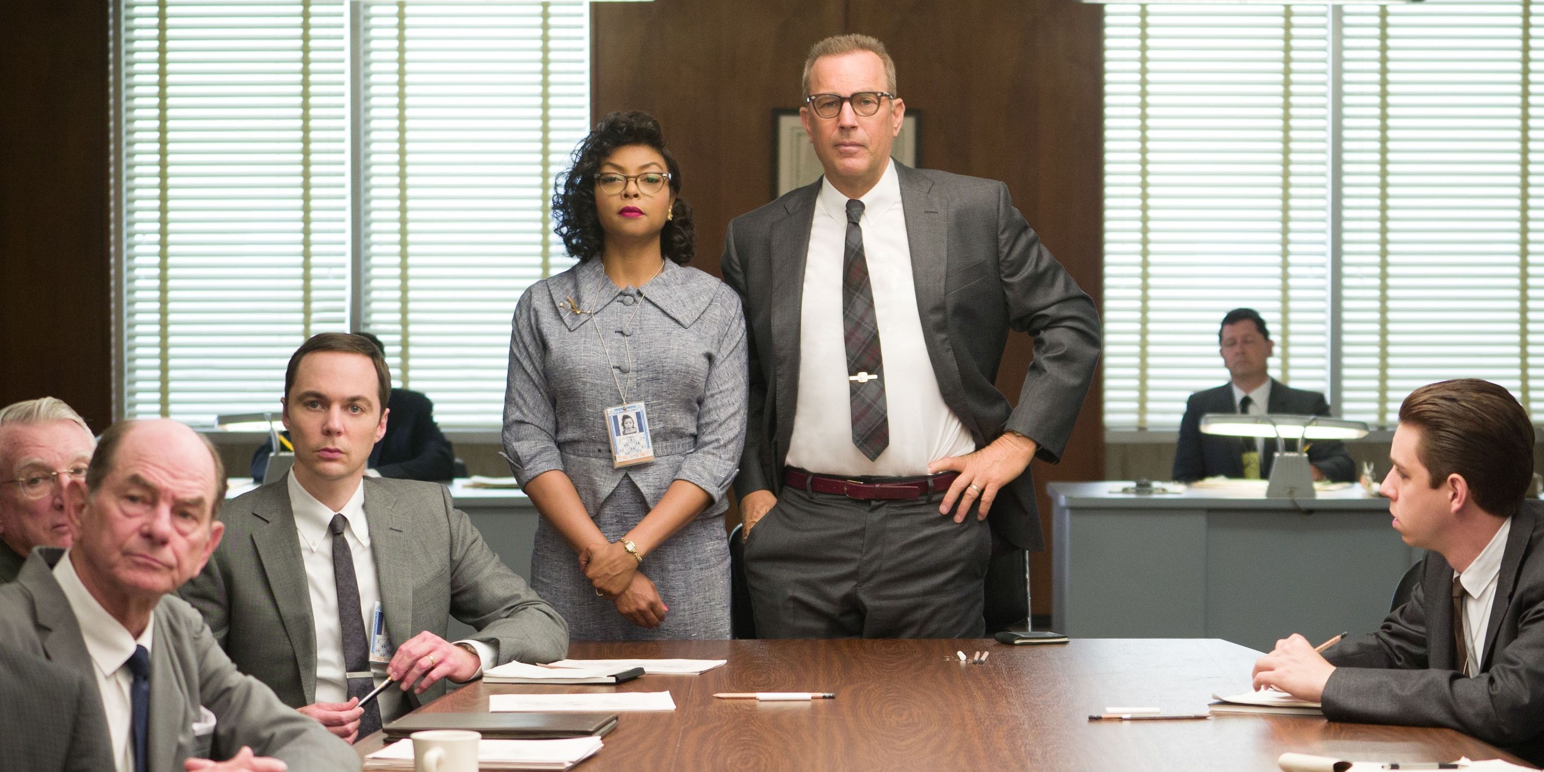 Katherine G. Johnson (Taraji P. Henson) standing with Al Harrison (Kevin Costner) at a board meeting in Hidden Figures