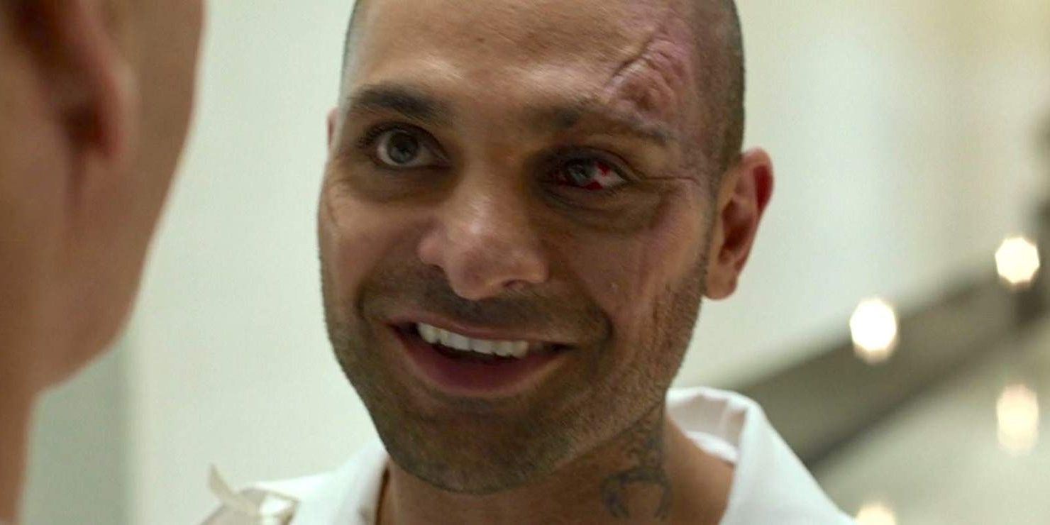 Michael Mando as Mac Gargan smiling with a scar on his face in Spider-Man: Homecoming.