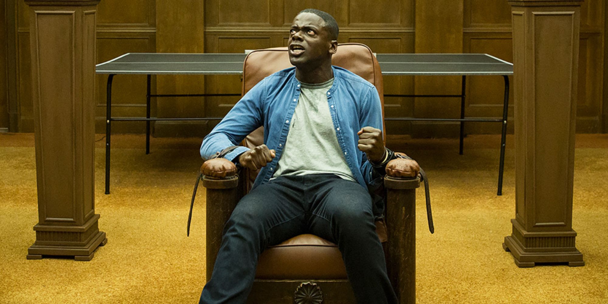 Daniel Kaluuya as Chris tied to a chair and looking terrified in Jordan Peele's horror movie Get Out