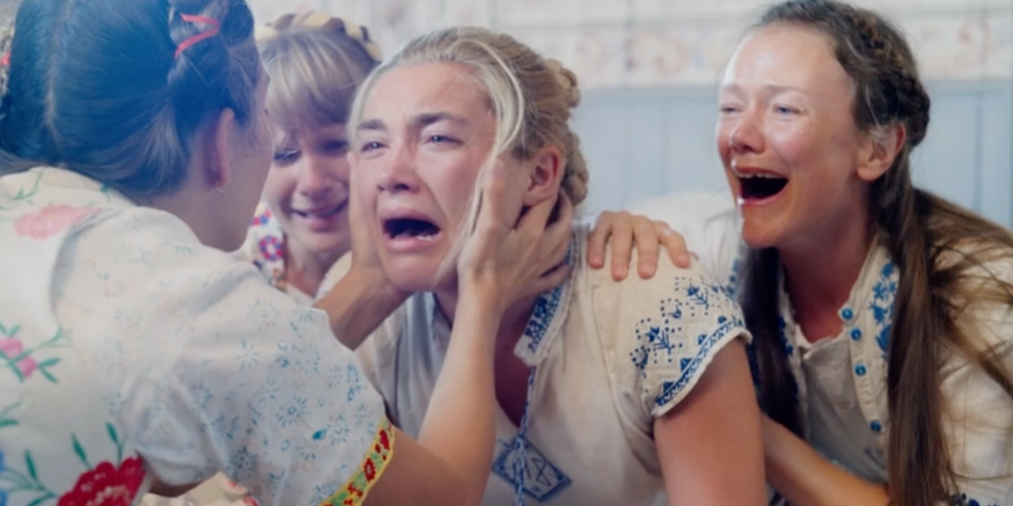 Dani (Florence Pugh) cries with support from the commune in 'Midsommar'.