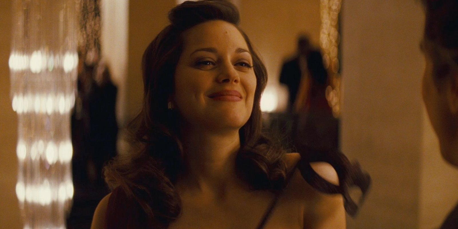 Miranda Tate smiling at a party in The Dark Knight Rises