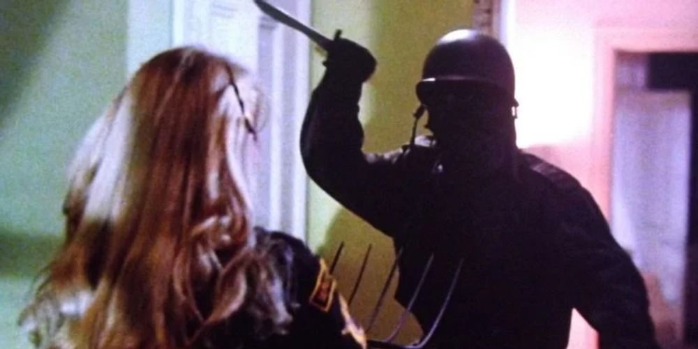 A soldier with a knife about to stab a woman in The Prowler (1981)