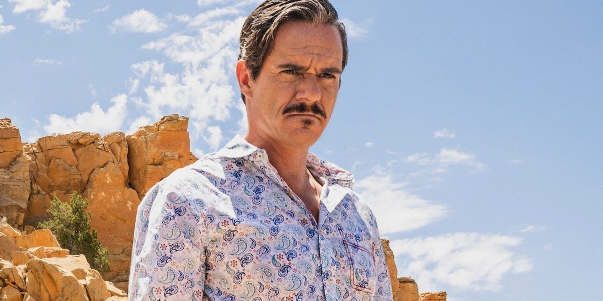 Lalo Salamanca in the desert looking down at something in  'Better Call Saul'