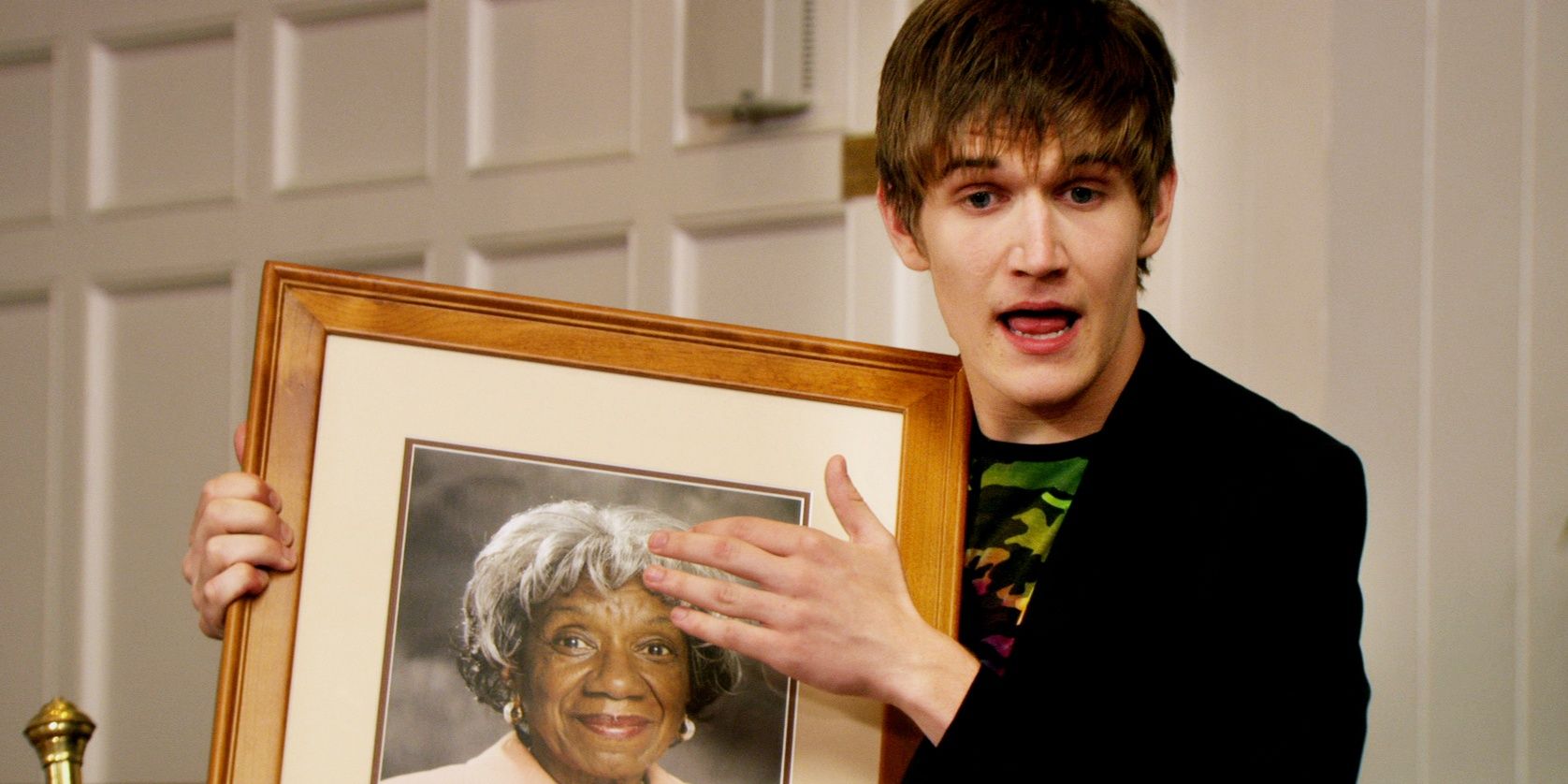 Main character Zack Stone holding a framed picture.