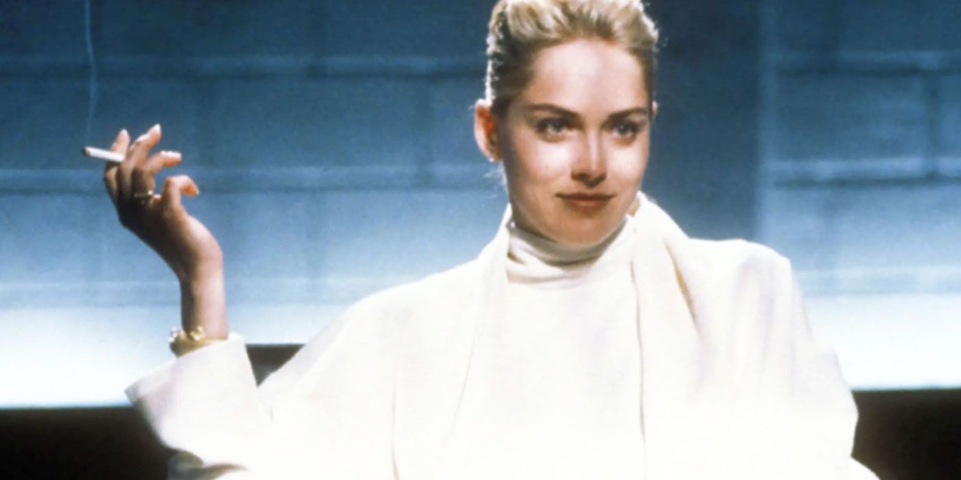 Sharon Stone as Catherine Tramell, sat in a white outfit smoking a cigarette in Basic Instict