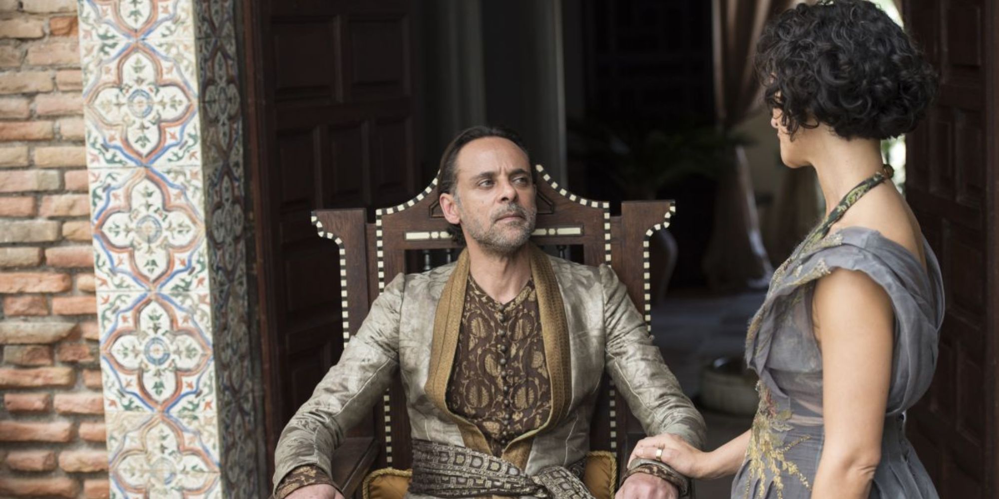 Doran Martell sitting down and looking up at a woman in Game of Thrones