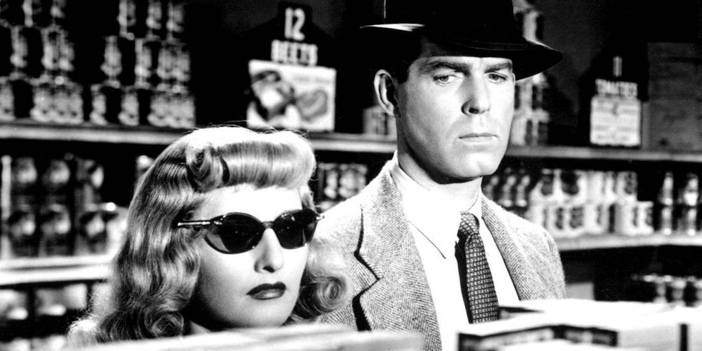 Barbara Stanwyck standing next to Fred MacMurray looking over a shelf in Double Indemnity.