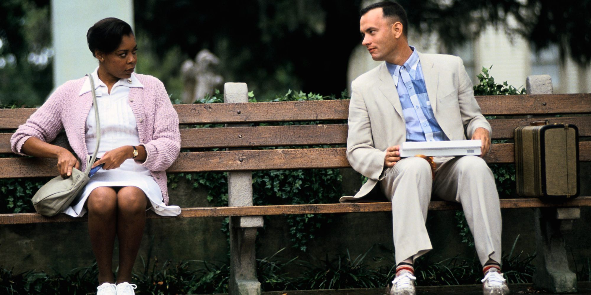 Forrest sitting next to a woman in Forrest Gump.