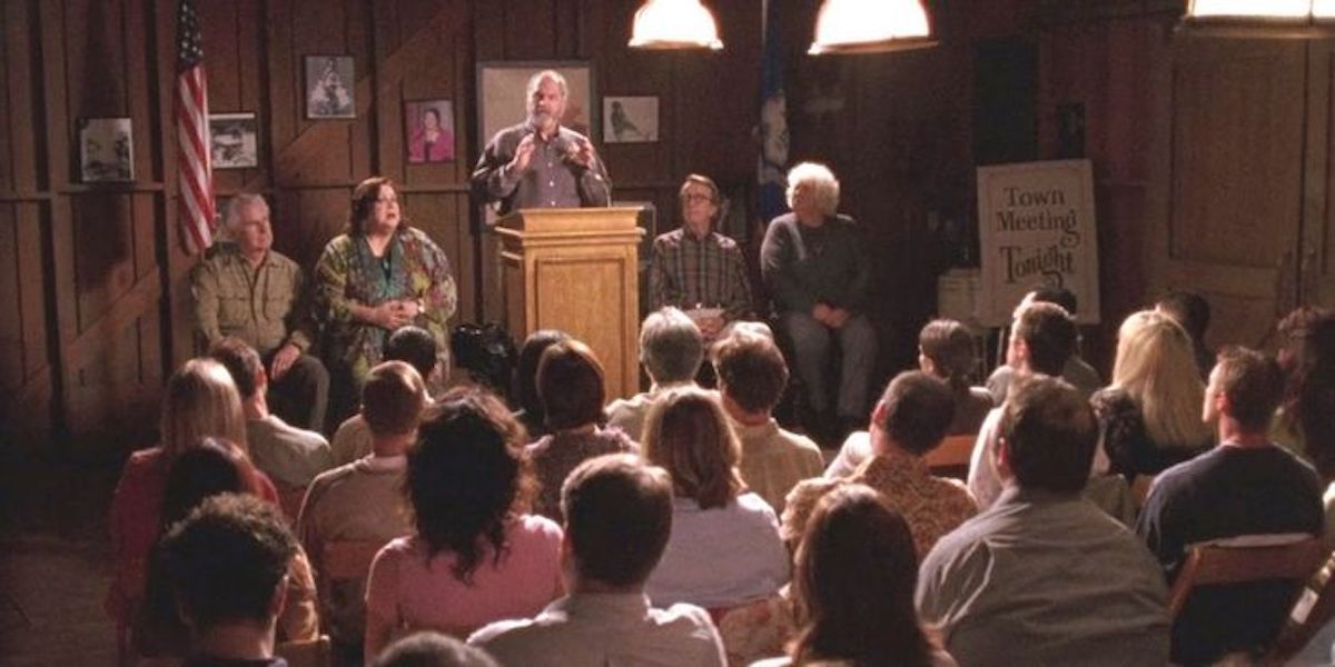 Taylor presiding over a town meeting in Gilmore Girls.