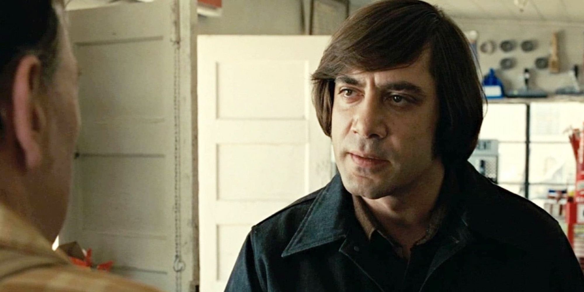 Javiar Bardem as Anton Chigurh talking to a store owner in No Country For Old Men