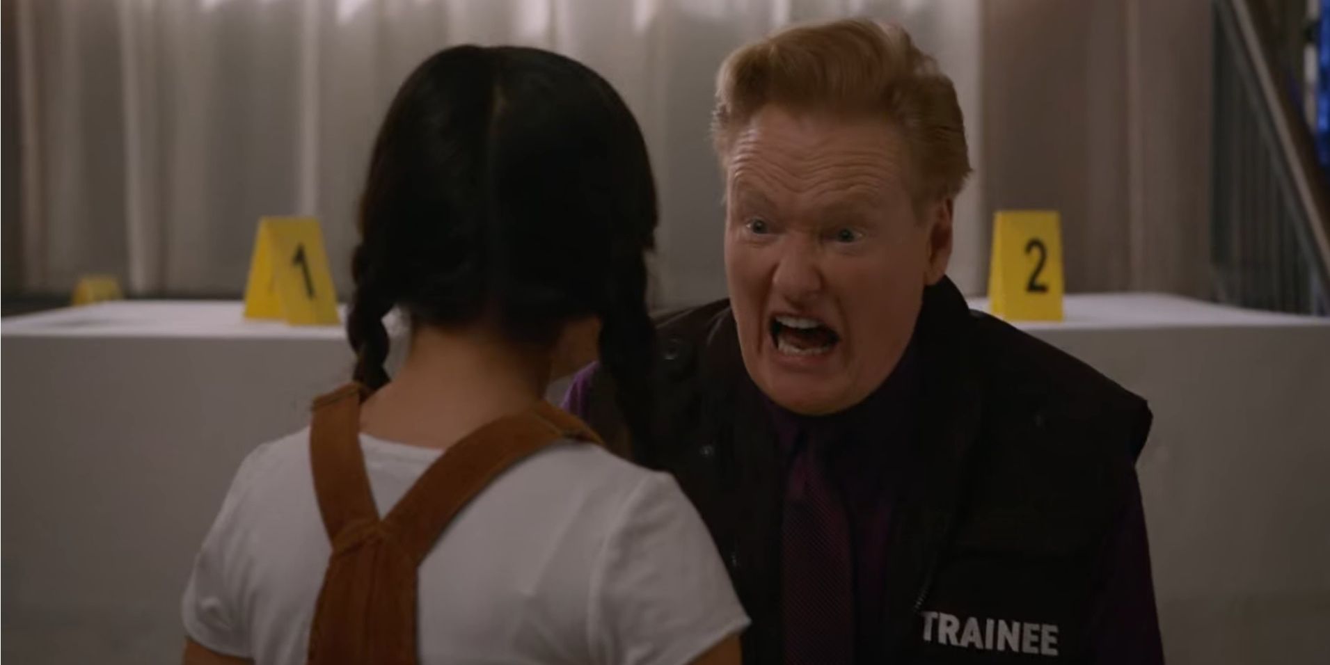 Conan O'Brien makes a scary face at a little girl in Murderville.