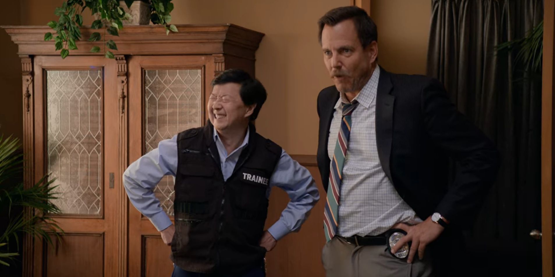 Ken Jeong laughs next to Terry Seattle in Murderville.
