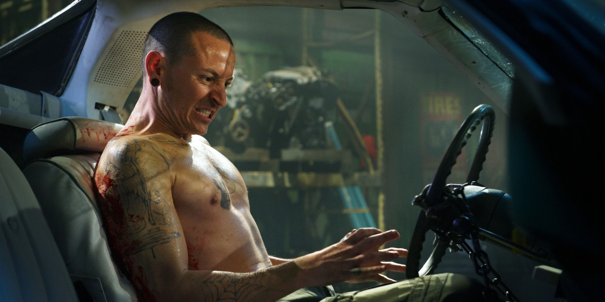 Chester Bennington as Evan glued to his car seat in Saw 3D