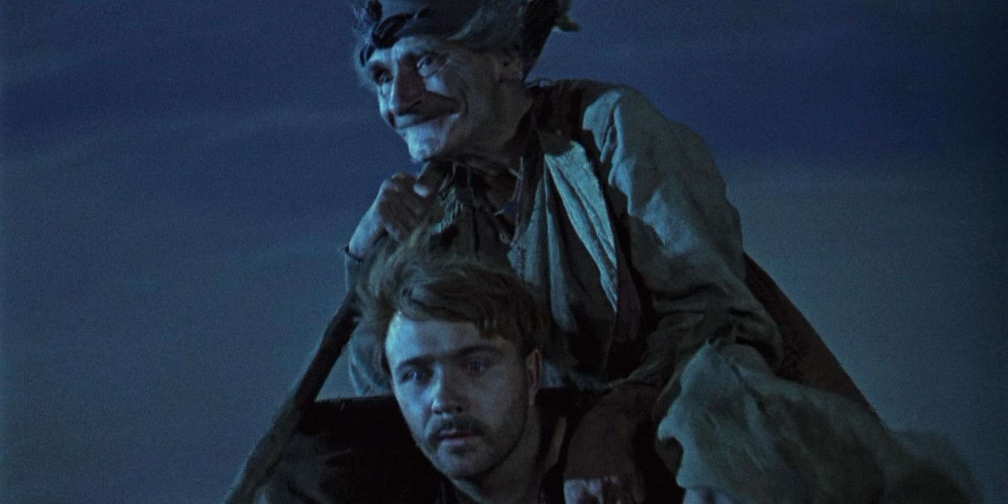 An old man sitting on a younger man&rsquo;s shoulders in Viy 1967