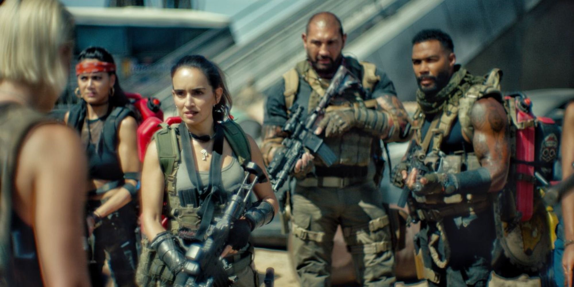 The cast of Zack Snyder&rsquo;s Army of the Dead wearing military gear and holding guns