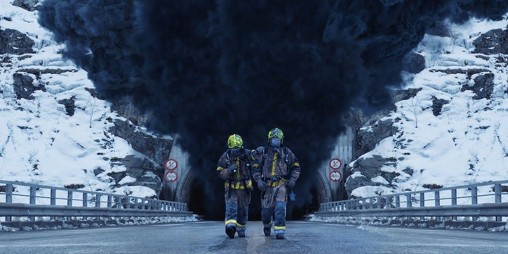 Two crew members walking away from the dangerous tunnel