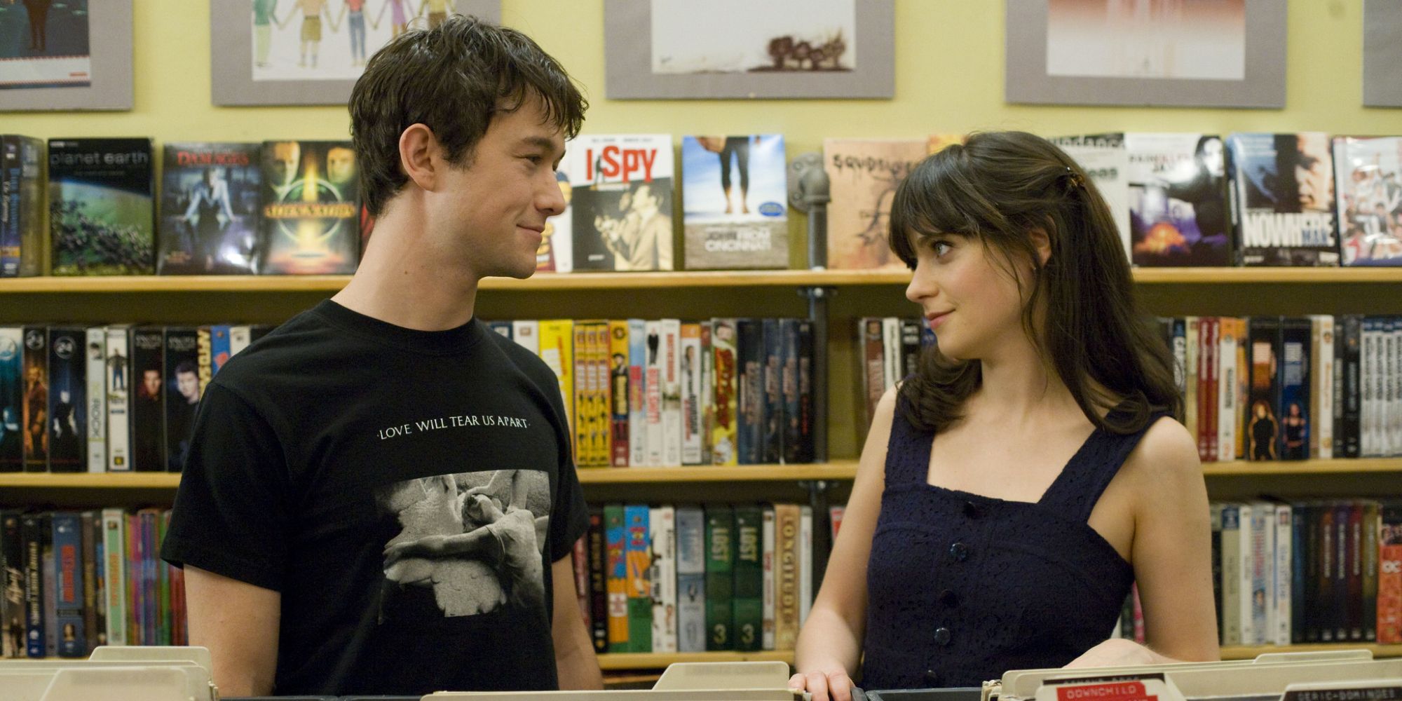 Summer, played by Zooey Deschanel, and Tom, played by Joseph Gordon-Levitt, looking at each other in a record store from 500 Days of Summer