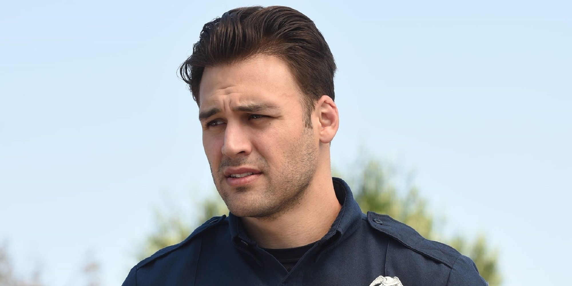 Eddie, played by Ryan Guzman, looks off to the left in a scene from '9-1-1.'