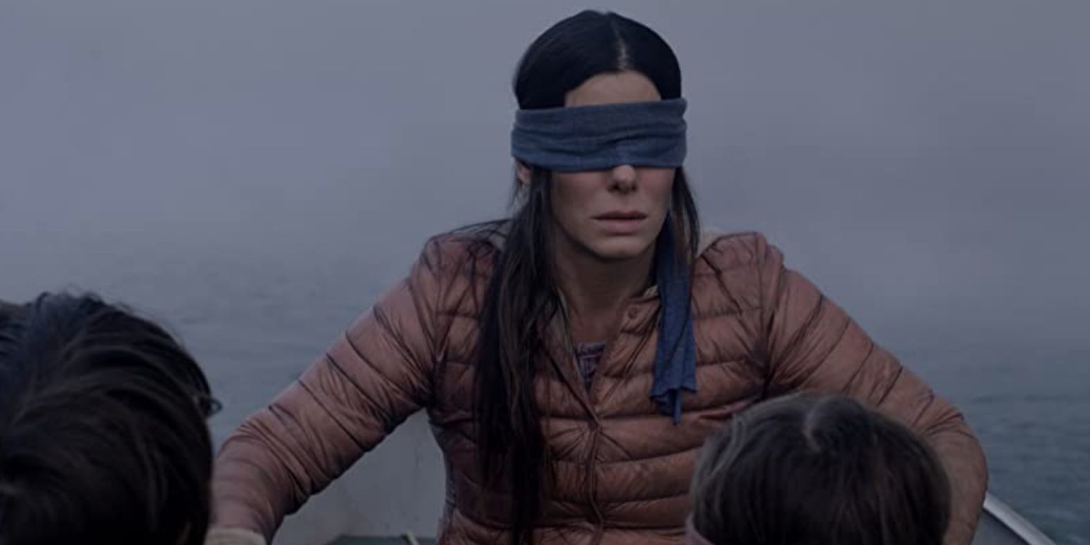 Sandra Bullock blindfolded in a boat with two children in the movie Bird Box