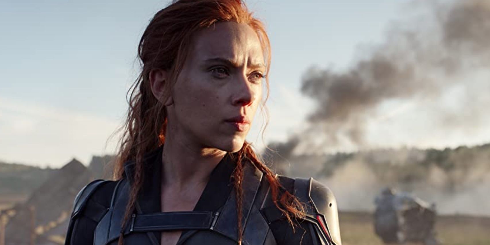 Scarlett Johansson as Natasha Romanoff standing heroically at the end of Black Widow.